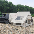 Inflatable Car Camping Tent side view on rocky ground, showing its clear panel and tailgate connection