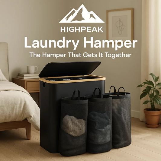 HighPeak 3-Section Laundry Hamper in black with bamboo lid and removable mesh bags in a bedroom setting