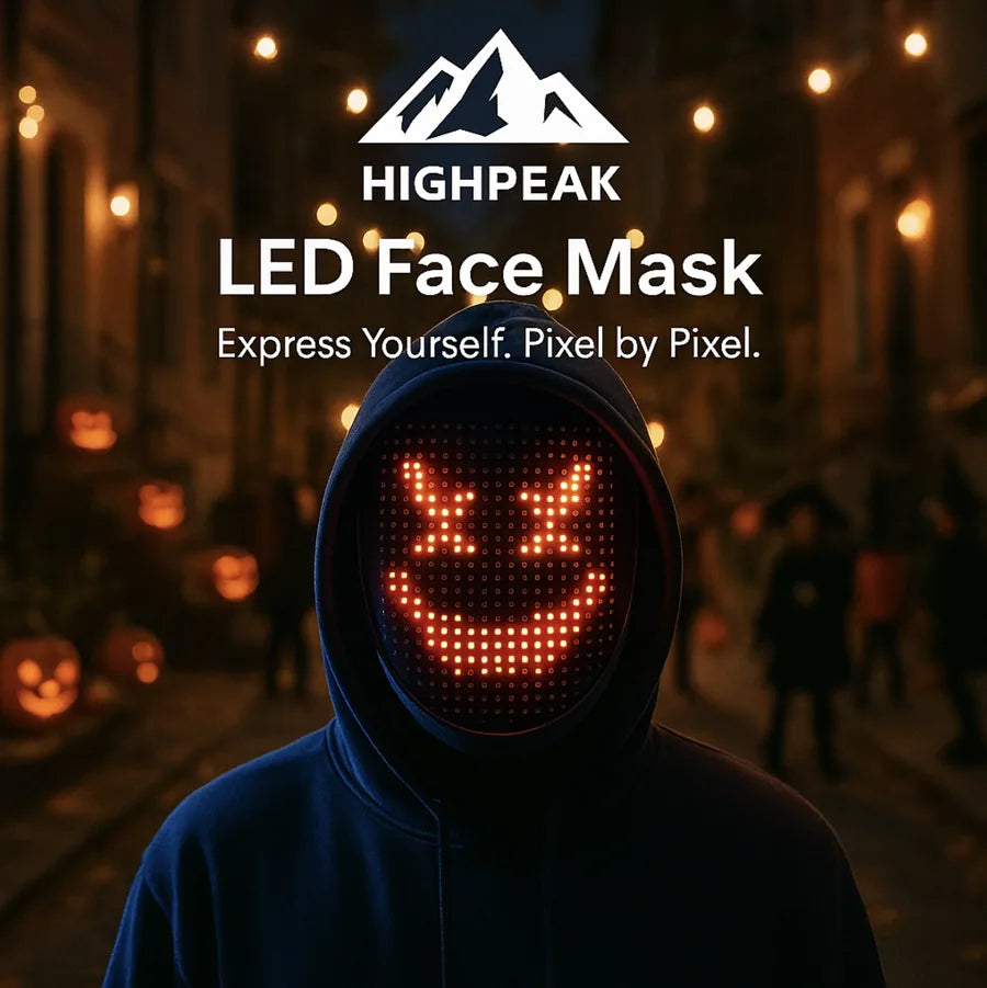 HighPeak LED Face Mask glowing orange with pixelated smiley face worn outdoors at night with Halloween pumpkins nearby