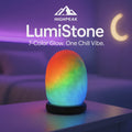HighPeak LumiStone glowing in 7-color LED on a nightstand with a calming purple background ambiance