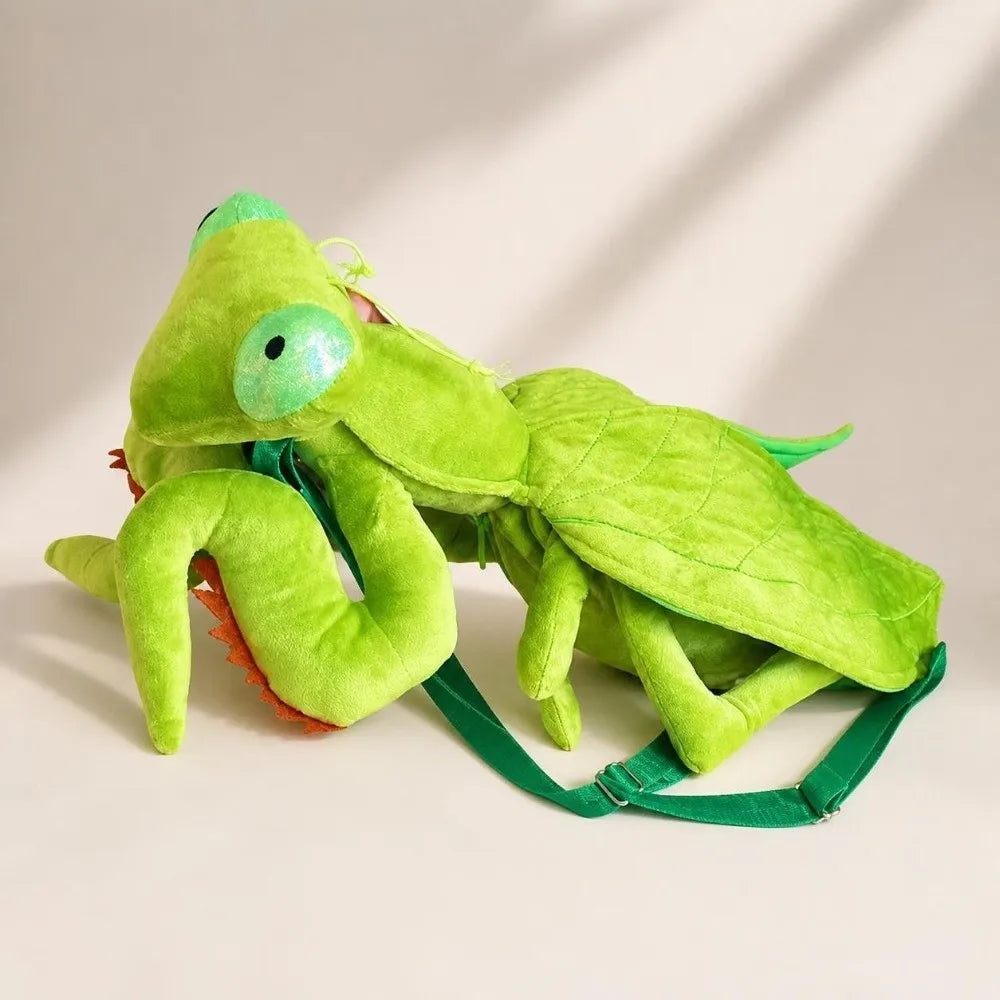 Green Mantis Plush Backpack reclining on a tabletop with folded front legs and stitched wings