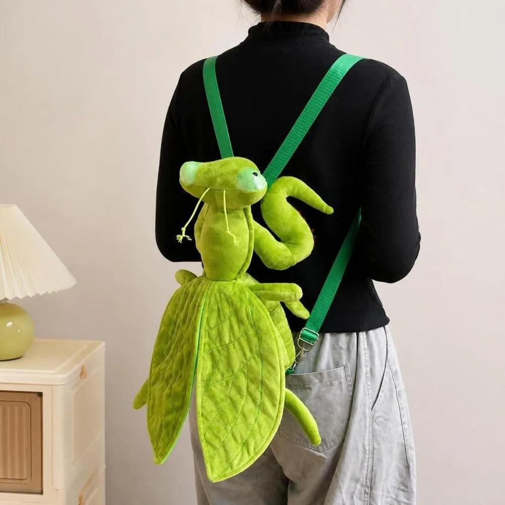 Rear view of Mantis Plush Backpack worn over a black top, showing green shoulder straps