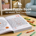 HighPeak Maze Puzzle Book 192 Pages open on table with crayons, showing Halloween-themed maze puzzles in cozy room.