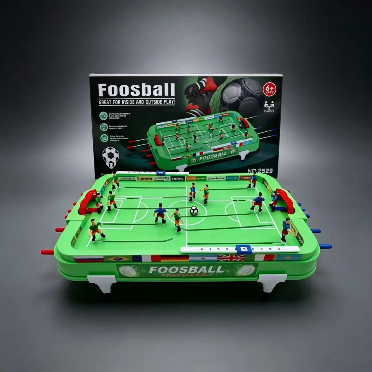 Assembled Mini Foosball Table with green pitch, red goals and retail packaging viewed from the front