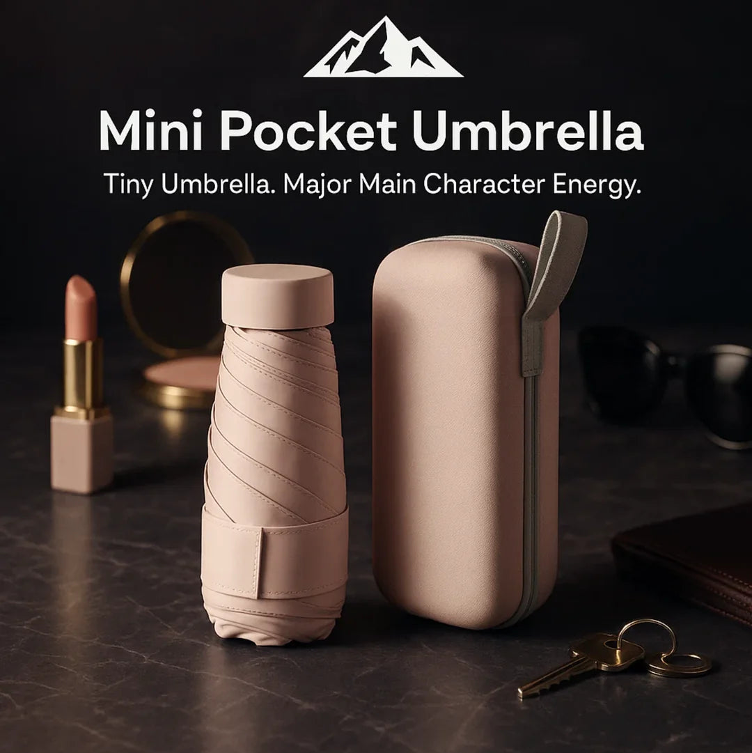 HighPeak Mini Pocket Umbrella in pastel pink with compact case on a dark marble surface with keys and lipstick nearby