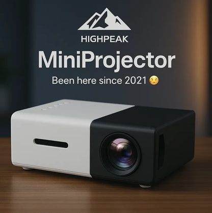 HighPeak MiniProjector in sleek black and white design with HD lens on wooden surface - compact home theater projector