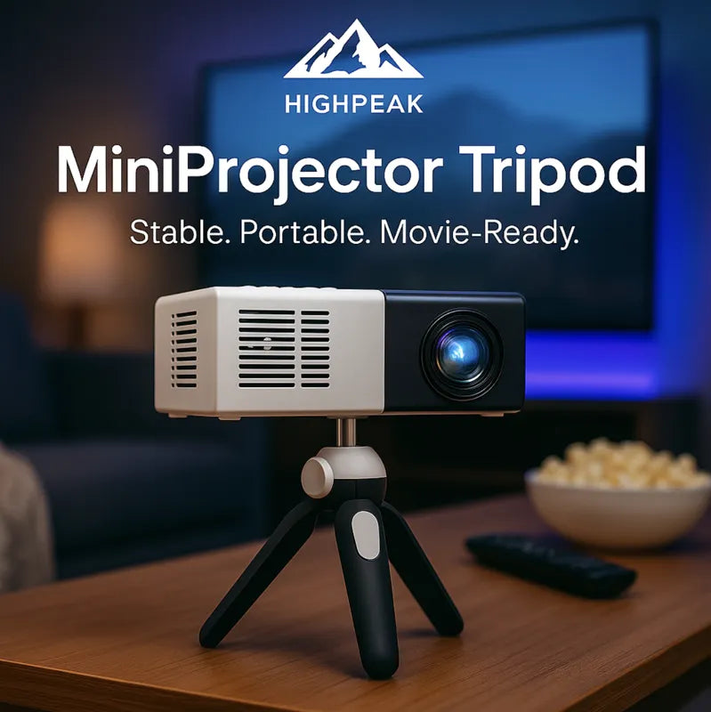 HighPeak MiniProjector Tripod in black supporting a compact projector on a wooden table in a cozy home theater setup