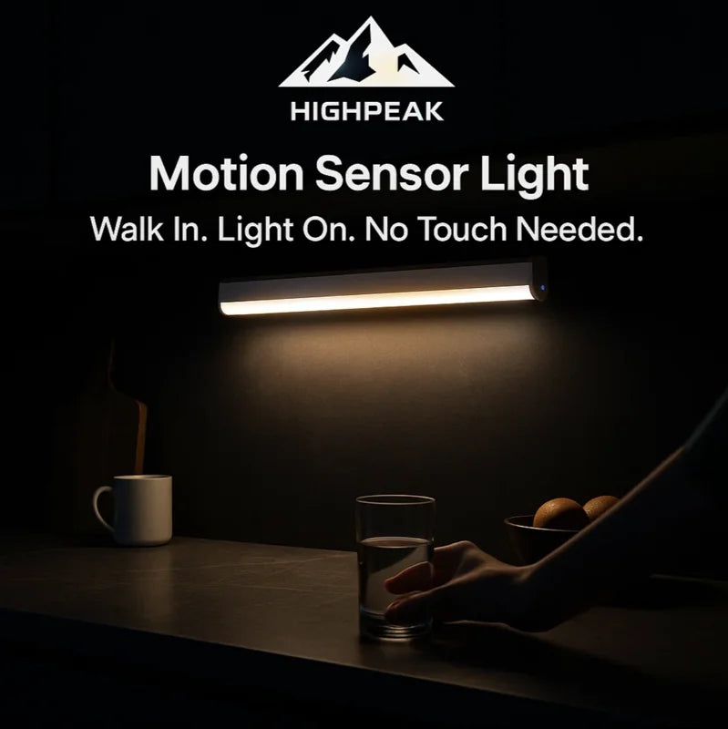 HighPeak Motion Sensor Light glowing warm white above kitchen counter with hand reaching for a glass in dim room