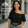 HighPeak Off Shoulder Crop Top in black worn by smiling woman outdoors, styled with high-waisted jeans and jewelry