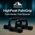 HighPeak PalmGrip™ push-up bars with black and red foam grips on a concrete floor for stable upper body workouts.