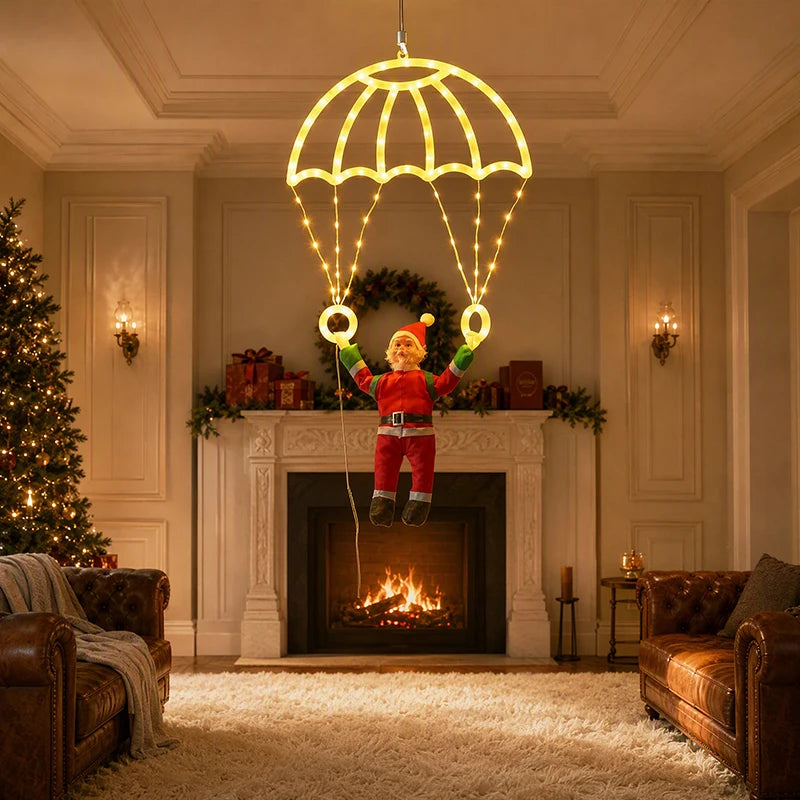 Warm white Parachuting Santa Lights hanging in a Christmas living room in front of a fireplace.