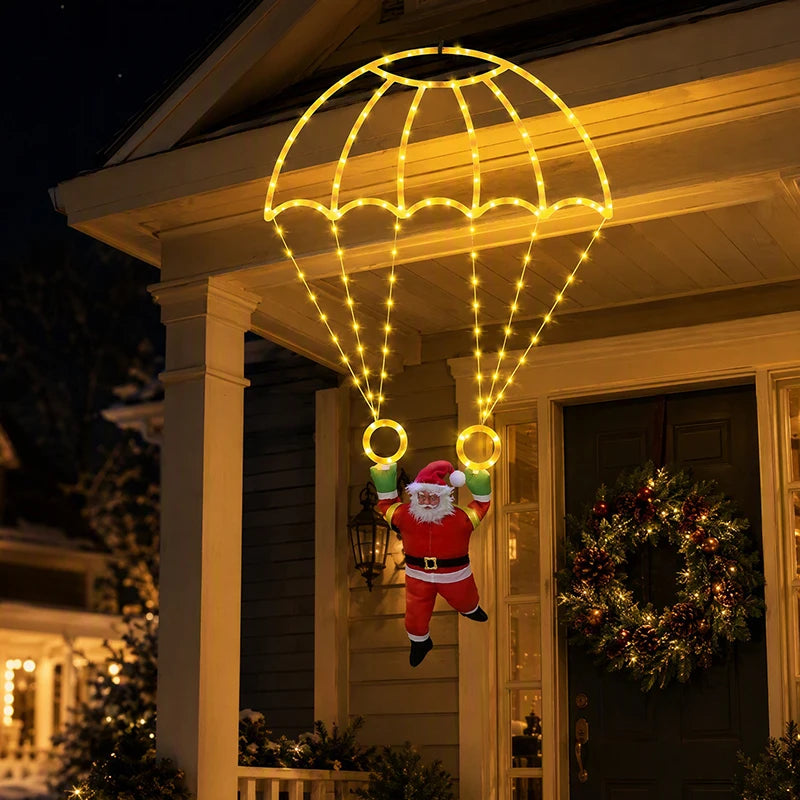 Warm white Parachuting Santa Lights illuminating a festive porch with Santa suspended below the parachute.