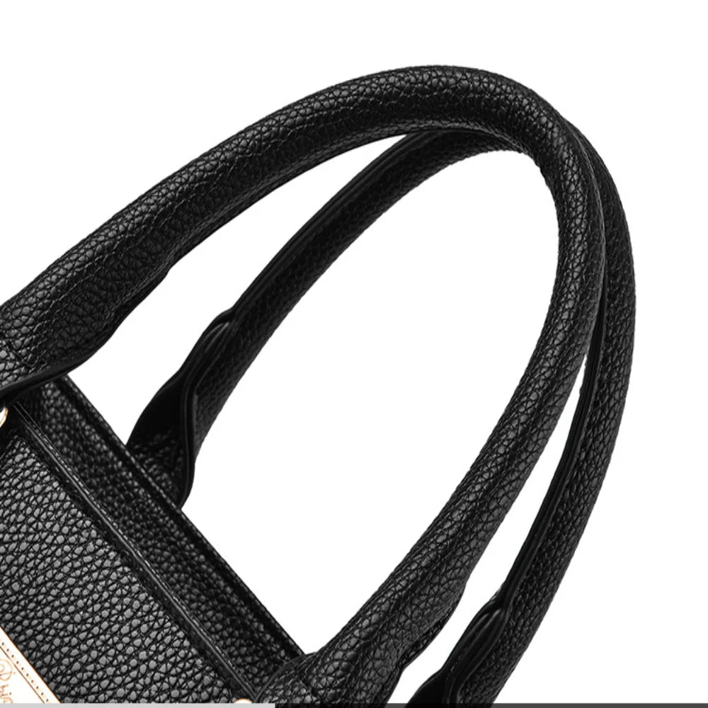 Pebbled Charm Shoulder Purse close-up of the black pebbled top handles and stitched handle attachments.