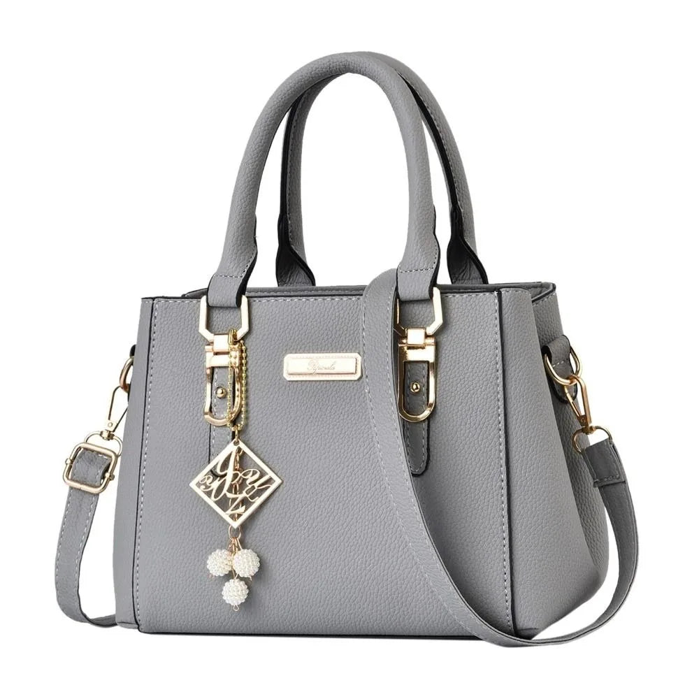 Pebbled Charm Shoulder Purse in grey showing pebbled texture, gold-tone hardware and shoulder strap.
