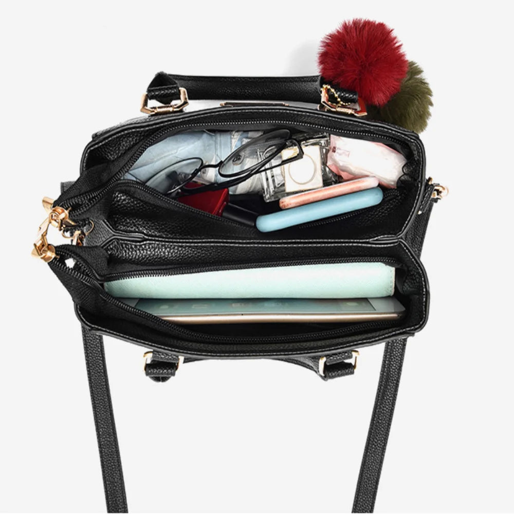 Pebbled Charm Shoulder Purse open interior with compartments holding a phone, wallet, glasses and small essentials.