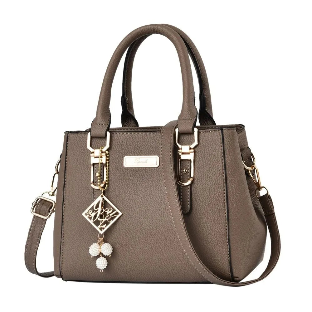 Pebbled Charm Shoulder Purse in khaki showing rounded handles, pebbled texture and gold-tone accents.