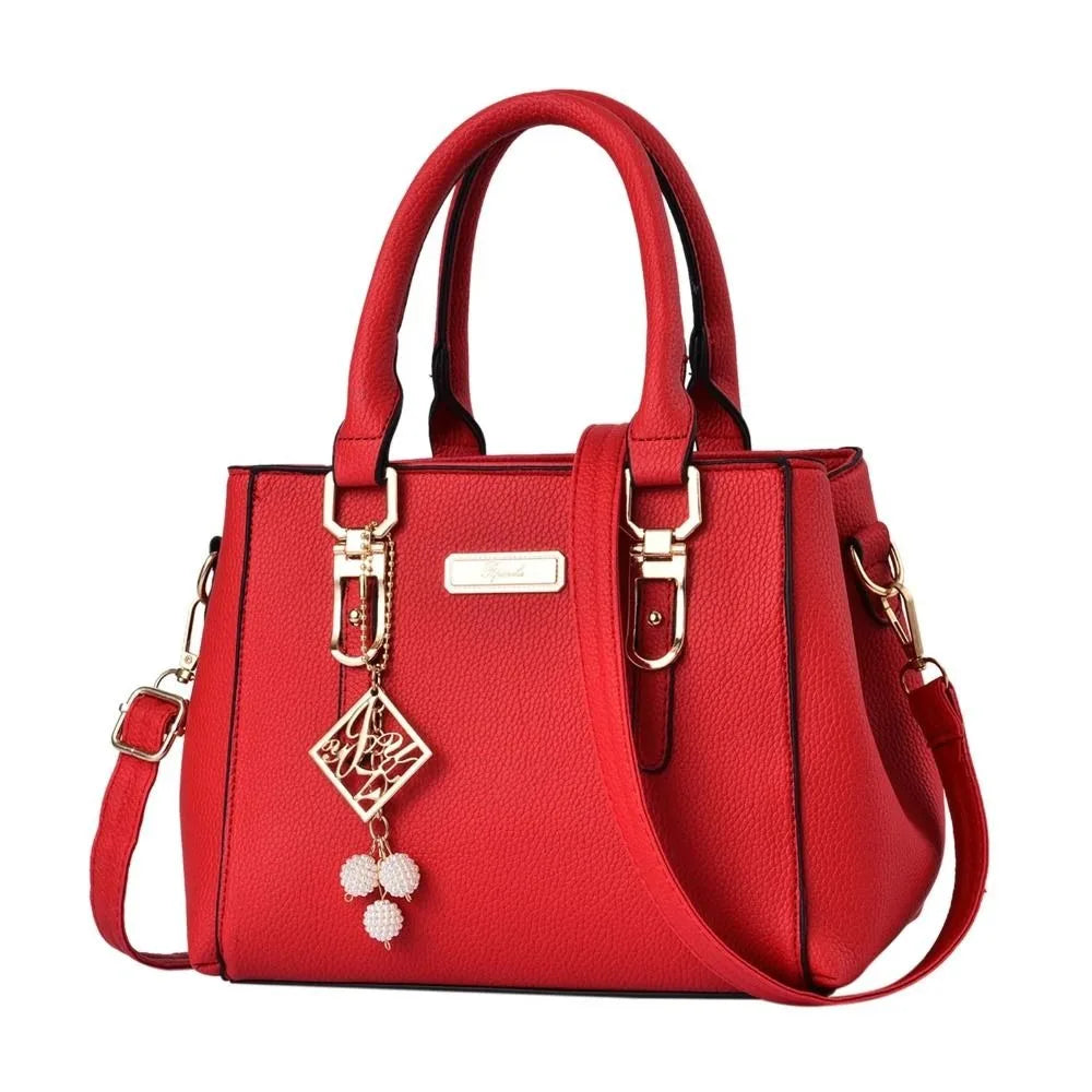 Pebbled Charm Shoulder Purse in red showing the pebbled finish, top handles and decorative charm.