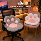 Two plush cat paw shaped seat cushions displayed on chairs in a cozy home office setting. One cushion is gray with a pink center and pink paw pads, shown on a black office chair.