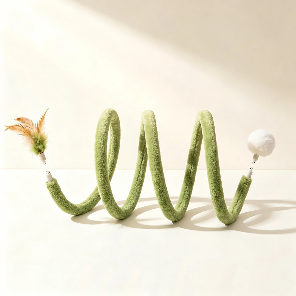Green plush spiral side view with feather and pom-pom attachments shown separately at the ends