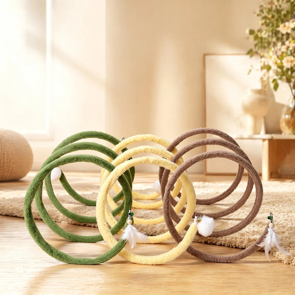 Green, yellow and brown Plush Cat Spiral Toys arranged on a wood floor beside a cream rug