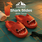 HighPeak Shark Slides in bright orange with shark-tooth design on poolside tiles alongside sunglasses and a drink