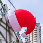 Giant Inflatable Santa Hat mounted beside a tall building