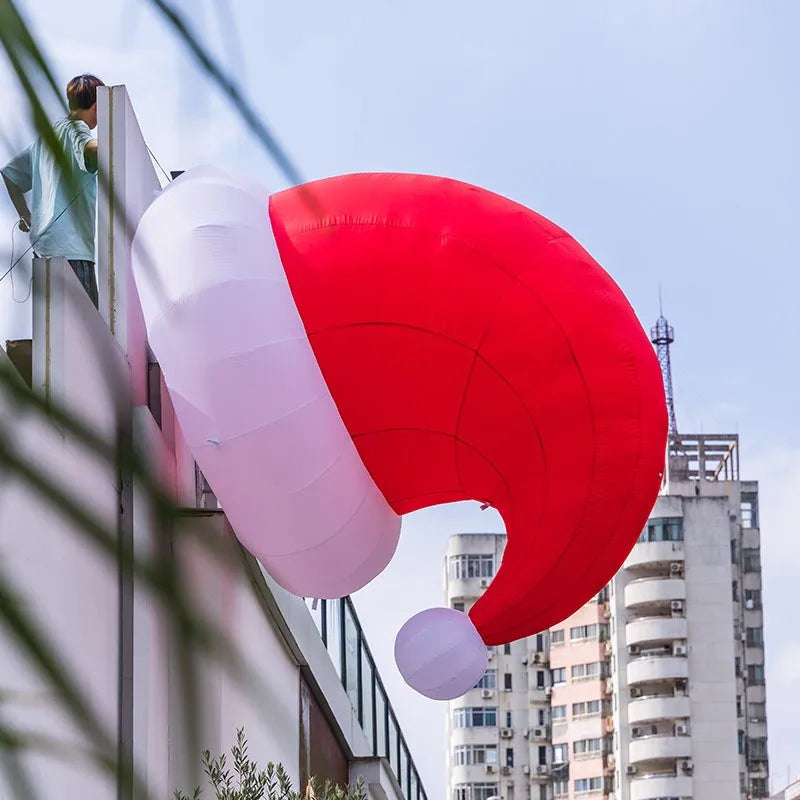 Giant Inflatable Santa Hat mounted beside a tall building