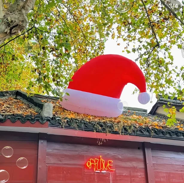 Giant Inflatable Santa Hat secured on a roof in daylight
