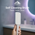 HighPeak Self Cleaning Brush in white held in hand with bathroom sink and round mirror background