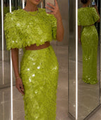 Green Sequin Skirt Set with a short-sleeve cropped top and maxi skirt, shown from the front and in a rear mirror reflection.
