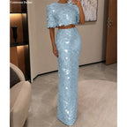 Light blue disc-sequin crop top and high-waist long skirt worn together in a full-length front view.