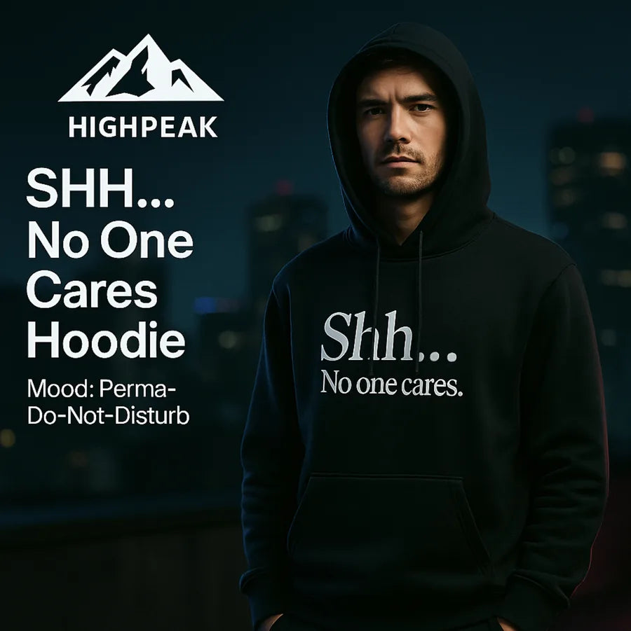 HighPeak SHH... No One Cares Hoodie in black with bold text, worn by a man in a moody nighttime urban setting
