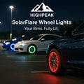HighPeak SolarFlare™ - LED Wheel Lights glowing red, green, and blue on cars parked at night in a lot