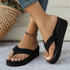 Black Solea Platform Flip Flops worn with one foot raised, showing the open toes and thick soles