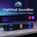 HighPeak SoundBar in black with blue ambient glow on desk, delivering powerful theater sound for laptop and desktop setups