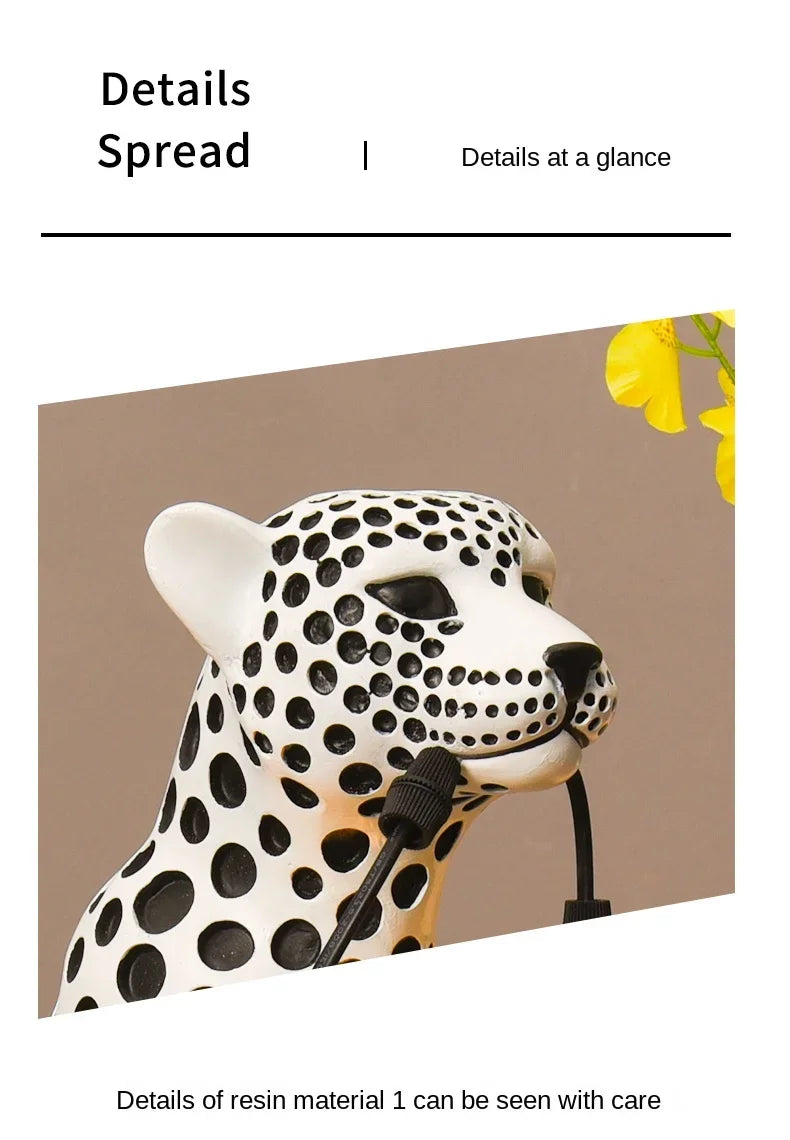 Close-up of the white Spotted Cheetah Premium Lamp face, black spots and lamp cord held in its mouth.
