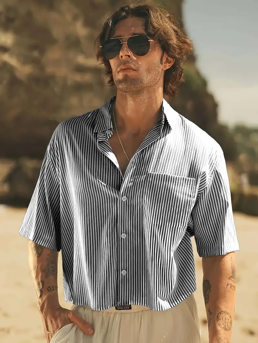 HighPeak Men’s Striped Beach Shirt in breathable black and white stripes worn on a sunny beach with sunglasses