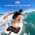 Surfer riding a wave with the black Surfboard Traction Pad Set beneath the rear foot on a white board