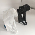 White and black T-Rex Skull Switch Covers displayed side by side