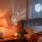 White T-Rex Skull Switch Cover styled beside a bed and lamp at night