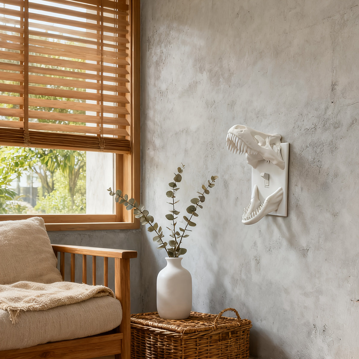 White T-Rex Skull Switch Cover styled on a living room wall beside a window and chair