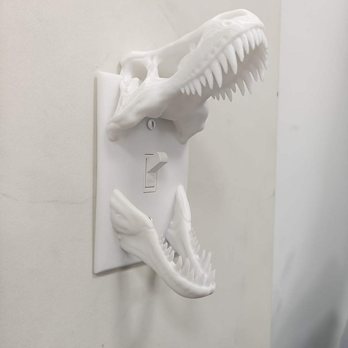 White T-Rex Skull Switch Cover showing sculpted teeth and toggle opening from the side