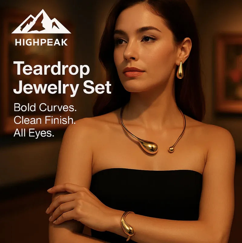 HighPeak Teardrop Jewelry Set in gold featuring bold curved necklace, earrings, and bracelet on model with black top