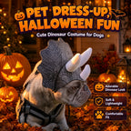 French Bulldog wearing a gray Triceratops pet costume beside pumpkins in a Halloween scene