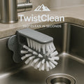 TwistClean™ - Cup & Glass Scrubber in gray mounted on a stainless steel sink with white bristles cleaning inside cups.