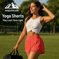 HighPeak Yoga Shorts in coral worn by smiling woman outdoors with white tank top, showcasing comfort and active lifestyle