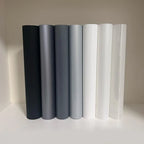 Holographic Window Projection Film supplier lineup of black, gray, white and transparent film rolls.