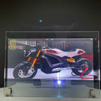 Holographic Window Projection Film glass-mounted demonstration showing a motorcycle with the projector behind it.