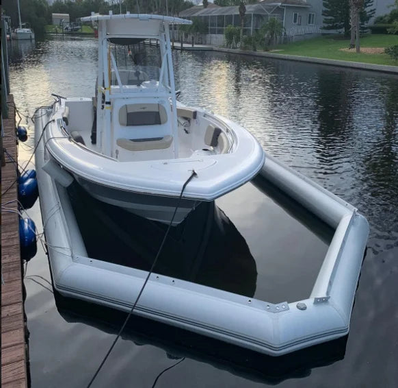 Inflatable Boat Dry Dock supporting a center-console boat beside a residential waterfront dock
