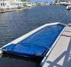 Inflatable Boat Dry Dock shown empty beside a pier with white inflatable rails and blue floor